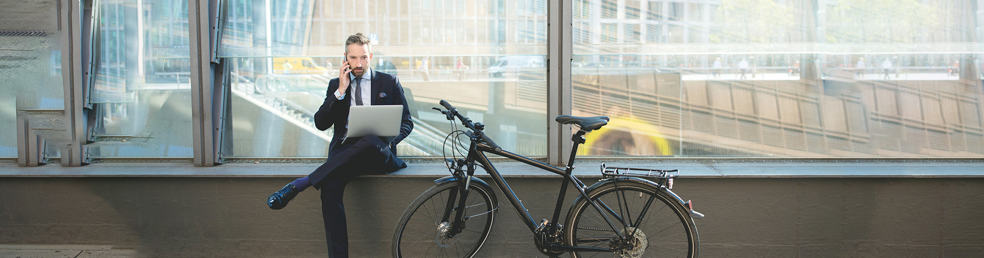 Businessman on phone using laptop
